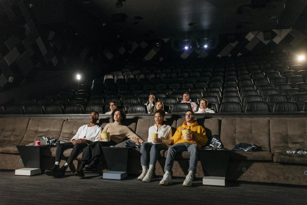 The Essentials of Blogging: Tips and Strategies for Success A diverse group of people enjoying a movie screening in an empty cinema with popcorn.