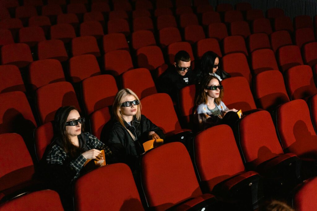Never Run Out of Ideas: Top Tips for Generating Fresh Blog Topics Group of people wearing 3D glasses in a cinema watching a movie, enjoying popcorn.